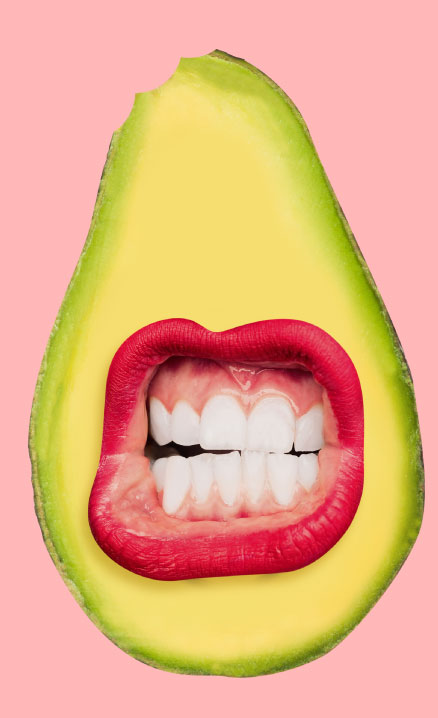 Avacado with a mouth with red lips in the center and teeth showing